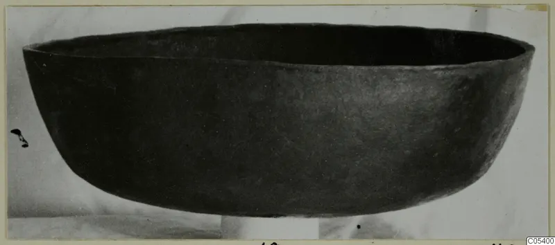 Dark wide bowl from Marion, seen from the side against a pale background.