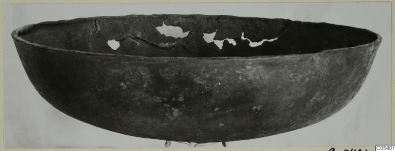 Wide open bowl from Marion with a dark surface and breaks along the far inner wall