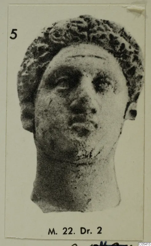 Head with curly hair and a broken-off neck, shown in a photograph mounted on a card