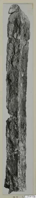 Long, narrow, weathered object from Amathus, photographed upright against a grey background.