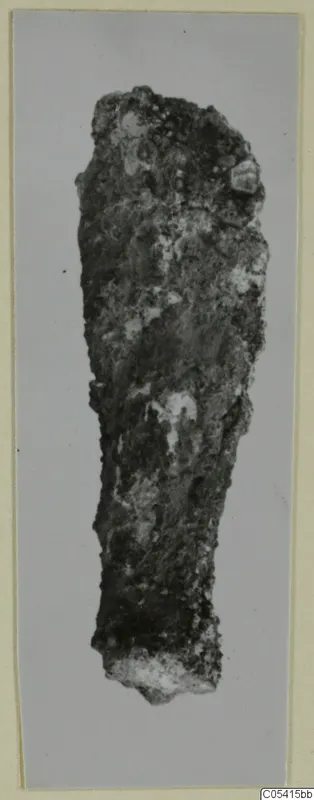Corroded iron weapon fragment from Amathus tombs 1–9, long and narrow, tapering to a broken lower end