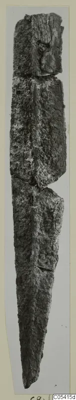 Heavily corroded metal sword or dagger from Amathus, tomb 2-26, photographed upright on a light grey background