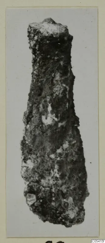 Corroded metal object from Amathus, tapering to a flat top, shown on a card mount