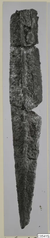 Corroded iron knife or blade from Amathus, standing upright with its point at the lower end.