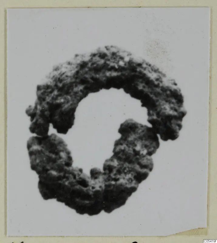 Corroded silver hair-ring from Marion, tombs 46–60, shown against a white background