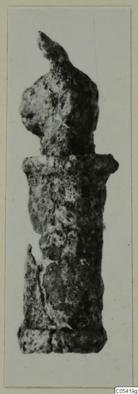 Corroded silver object with a knobbed top and cylindrical body, shown upright against a pale background.