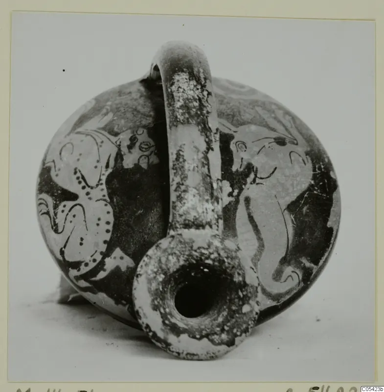 Round pottery vessel with a tall strap handle and a wide spout, decorated with large painted figures in dark paint