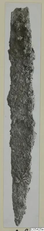 Heavily corroded iron knife blade from Marion, shown upright.