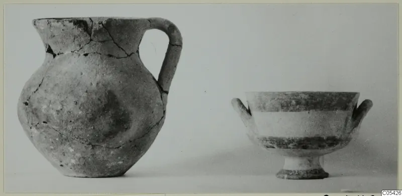 Pottery jug with a single loop handle and a footed bowl with two small handles, photographed side by side.