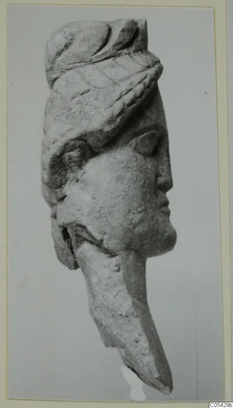 Limestone statuette head from Mersinaki, face in profile to the right, wearing a wrapped headdress