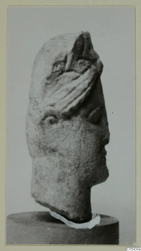 Limestone head from Mersinaki, shown in side profile on a stand