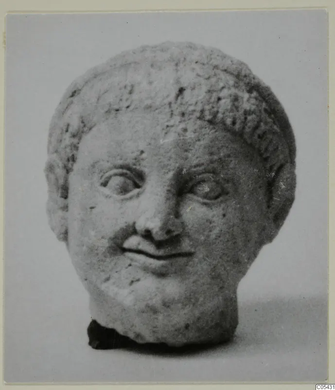 Terracotta limestone head from Mersinaki with short curled hair and a slight smile