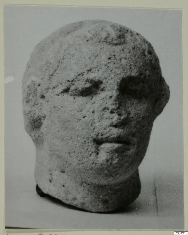 Limestone head from Mersinaki, shown three-quarter view against a plain background
