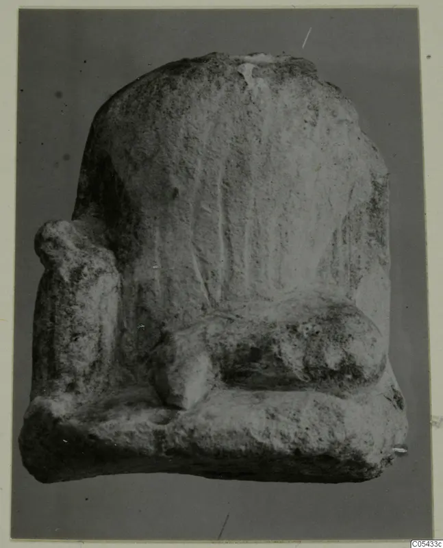 Limestone sculpture fragment from Mersinaki, a high-backed seat shape with a side block and a rounded projection.
