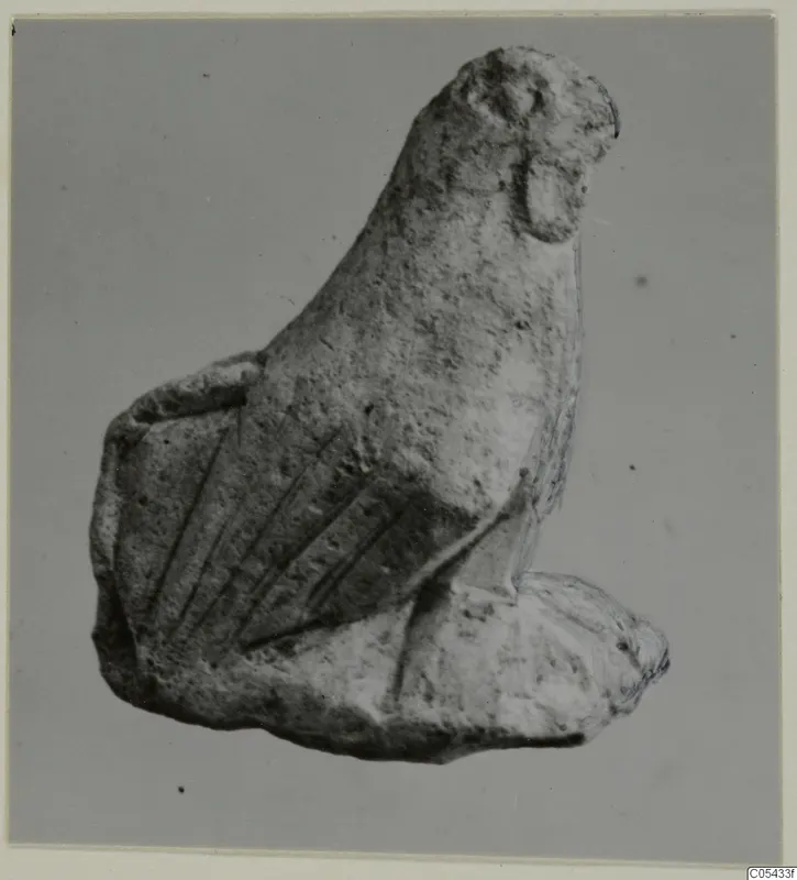 Limestone figurine from Mersinaki with a long neck, rounded head and parallel incised grooves on one side