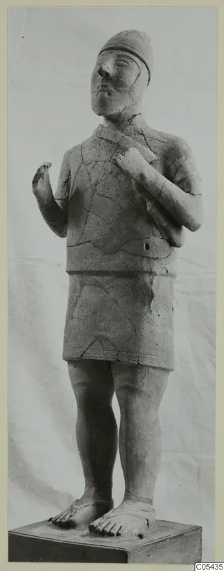 Terracotta statue of a standing figure with a close-fitting cap, short skirt and bare feet, on a wooden base