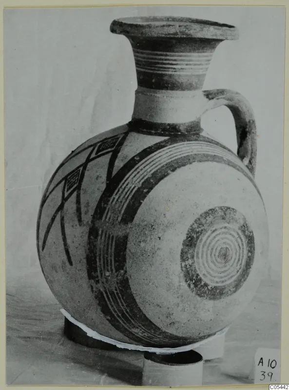 Pottery White Painted II jug with a flaring neck, single handle and dark painted bands and lattice panels