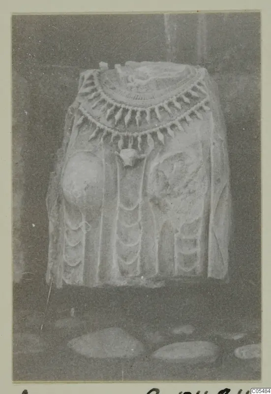 Carved stone statue fragment from Arsos with a broad pendant collar, photographed on a card mount