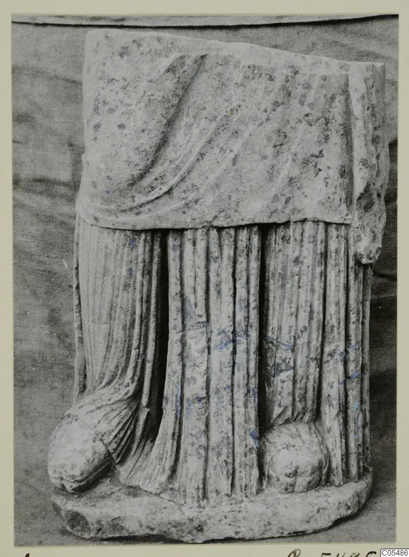 Carved stone sculpture fragment with draped folds, from Arsos