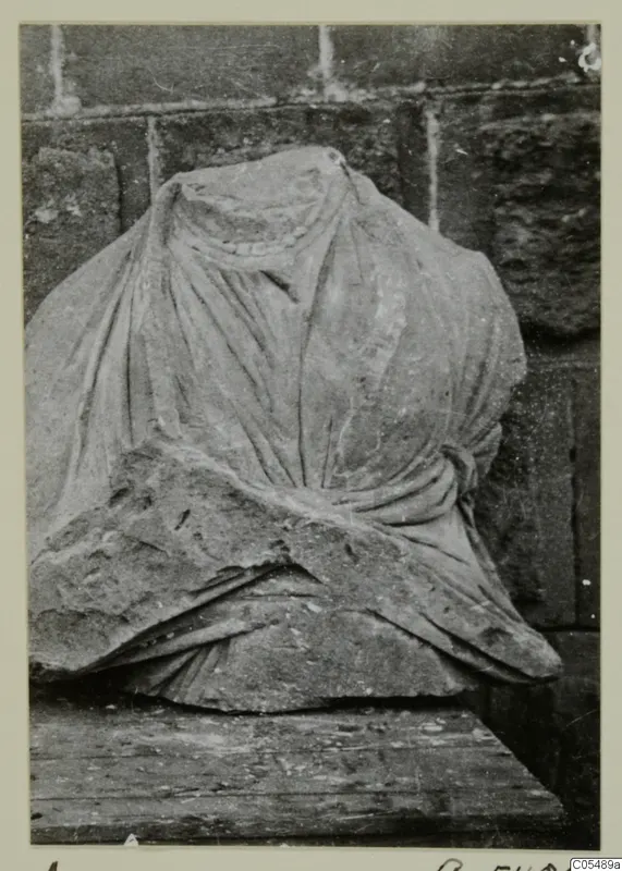Stone statue from Arsos: a headless draped figure in carved stone