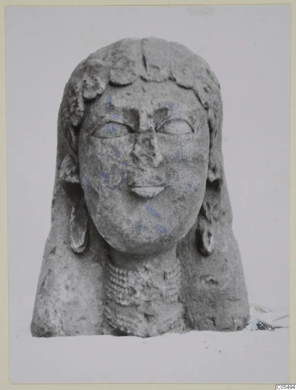 Limestone Proto-Cypriote sculpture of a head and upper body with traces of blue paint