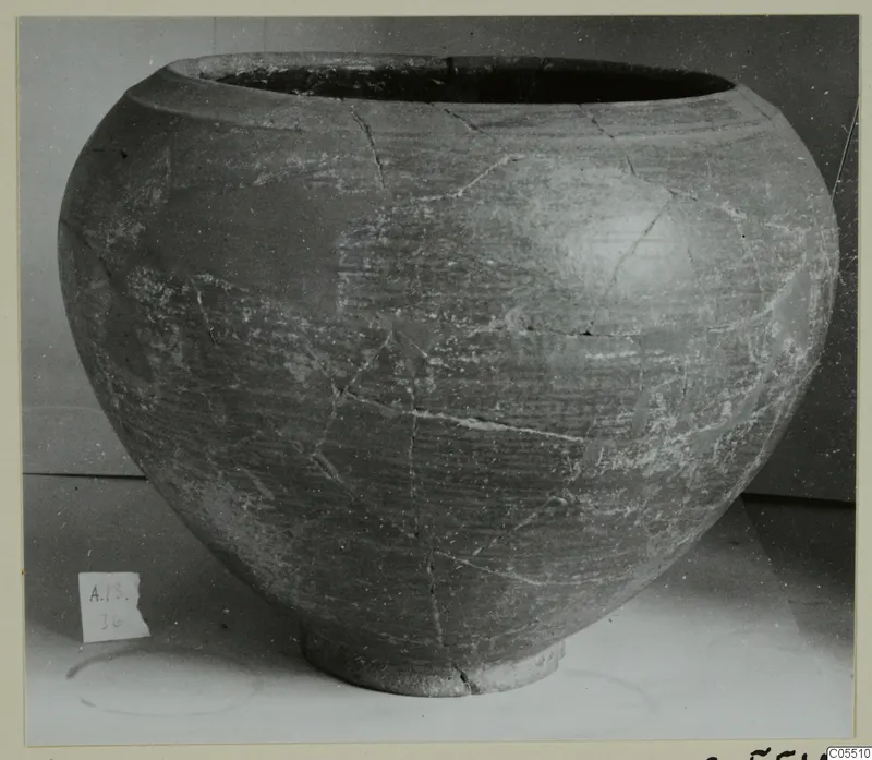 Pottery vessel with a wide mouth, rounded body and short foot, cracked and mended, from Amathus
