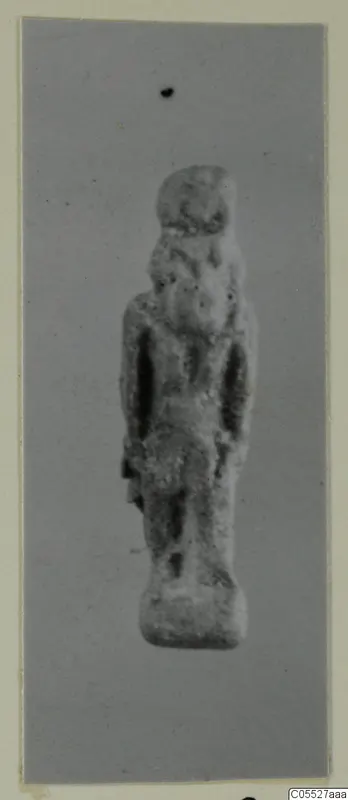 Small standing figurine labelled Thoth, photographed on a grey backdrop