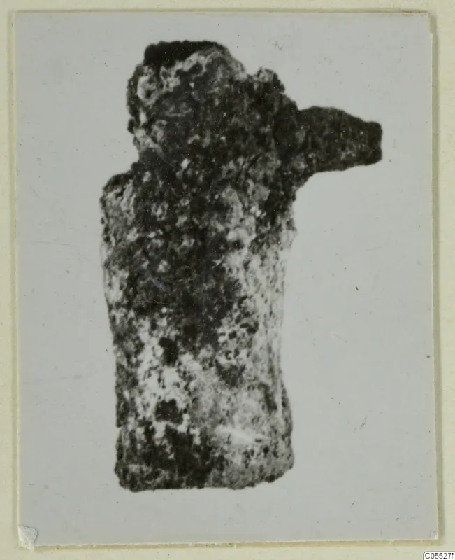 Corroded silver figure fragment from Marion, Tomb 40 B, with a single arm projecting to the right.