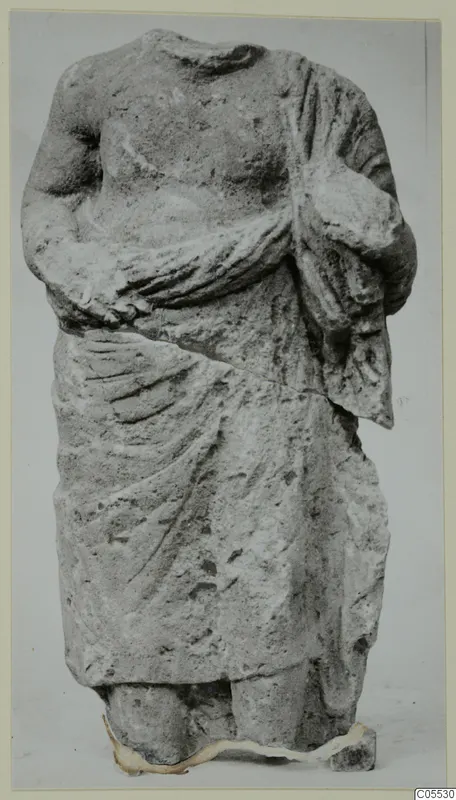 Headless draped stone statue from Mersinaki, shown frontally against a plain grey background.