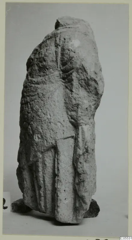 Limestone sculpture fragment of a draped standing figure from Mersinaki, top broken away