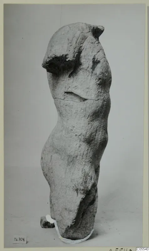 Limestone torso of a standing figure from Mersinaki, with head and arms missing.