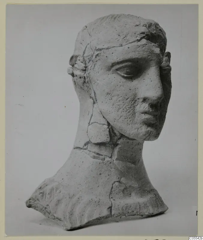 Head and upper torso of a figure from Mersinaki, pale clay, with cracks repaired