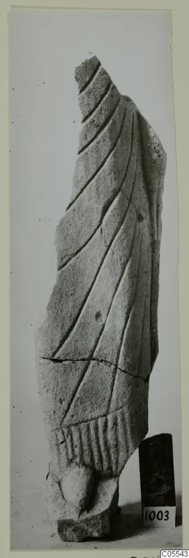 Broken limestone sculpture fragment from Mersinaki, carved with diagonal folds