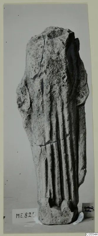 Limestone sculpture fragment from Mersinaki with vertical folds down the body, broken off at the top