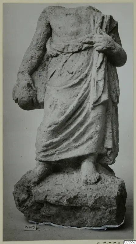 Headless, armless draped statue of a standing figure on a rough rock base, from Mersinaki