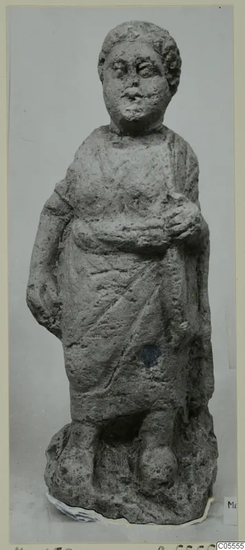 Standing draped figure from Mersinaki in grey terracotta limestone, on a rough irregular base