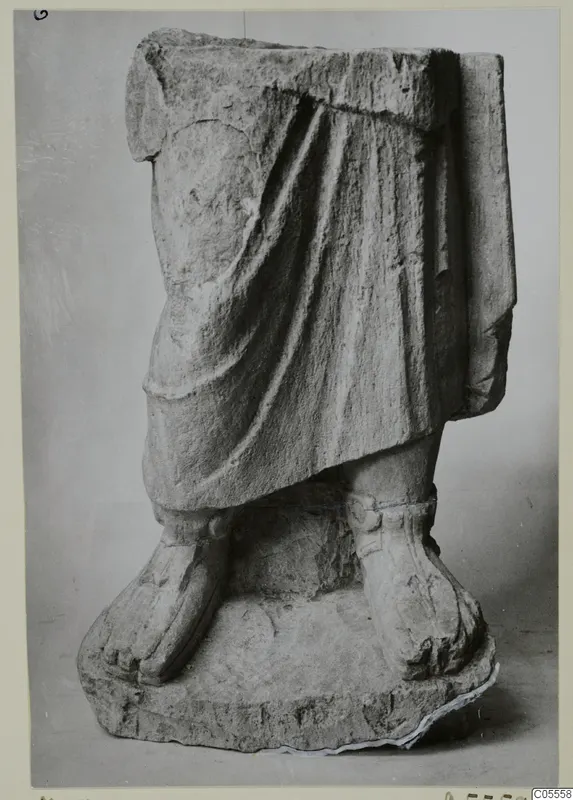 Statue fragment from Mersinaki: draped lower body and feet on a rectangular base.