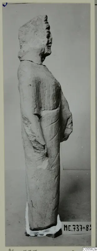 Standing limestone statue seen in profile, from Mersinaki