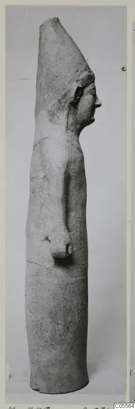 Tall terracotta statue of a standing figure in side profile, facing right, with a tall flat-topped headdress.