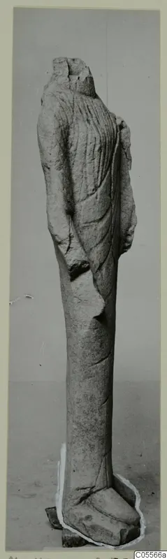 Standing limestone statue from Mersinaki, headless, wearing a long robe with vertical folds