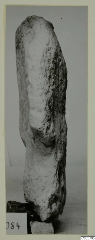 Limestone sculpture fragment from Mersinaki, standing upright against a plain grey backdrop