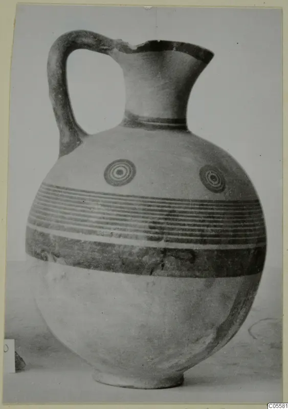 Pottery Black-on-Red I-III jug from Marion, with a loop handle, concentric circle motifs and horizontal bands