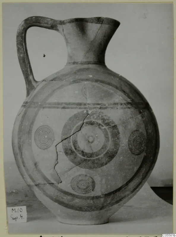 Pottery Black-on-Red I-III jug with one handle, a flared neck and painted concentric circles and bands