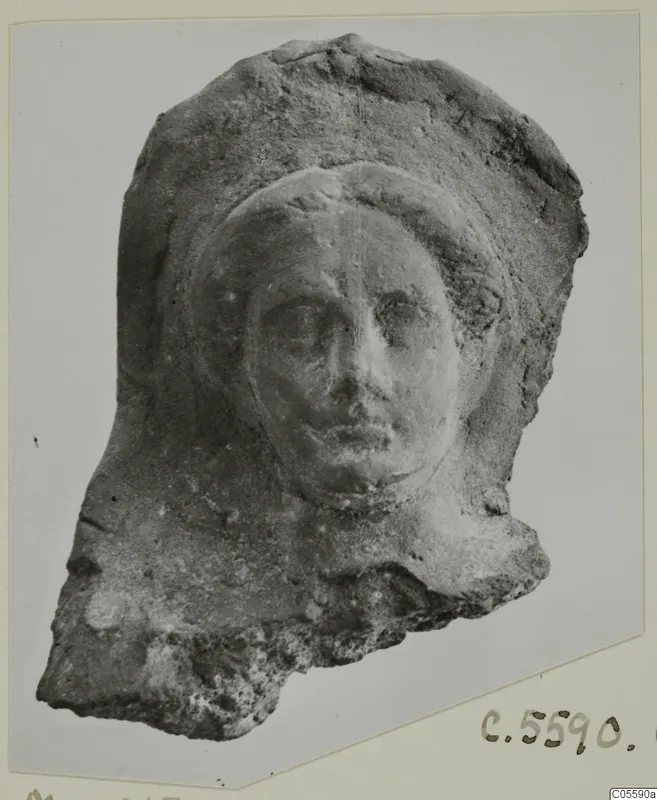 Fragmentary head with a relief face framed by a rounded covering, from Mersinaki