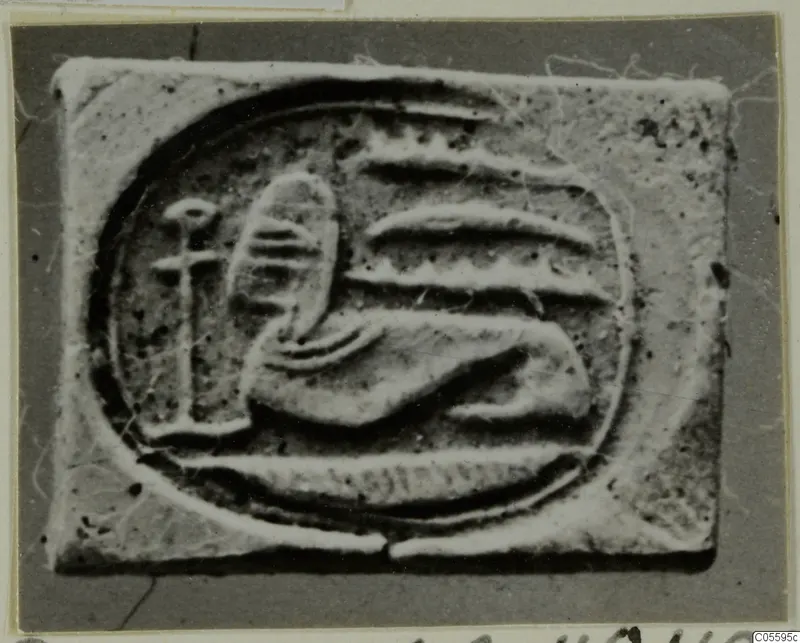 Glyptic: a rectangular seal with a raised design of a reclining form and a vertical stem inside an oval border