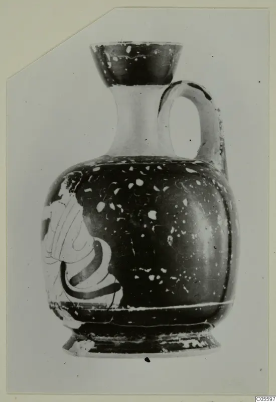 Jug with a flared mouth, one handle and a partly visible painted figure on its body