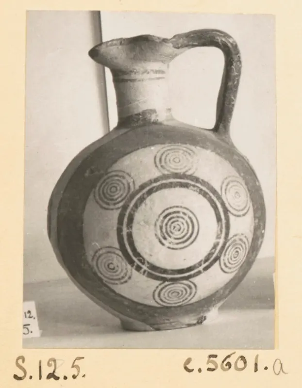 Pottery Bichrome III jug with dark concentric circles painted on a pale body