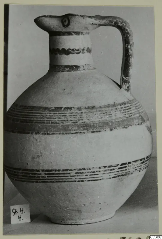 Pottery Bichrome IV jug (S.4.4) with a beak-shaped spout, strap handle and dark painted bands