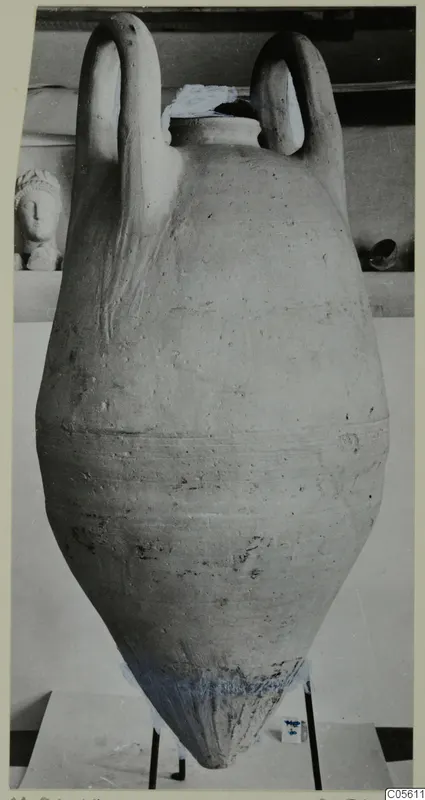 Pottery pithos with two loop handles and a pointed base, standing on a metal stand