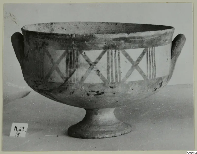 Pottery White Painted I bowl on a pedestal foot, with two loop handles and painted crosses and vertical stripes